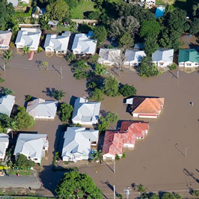 Overhead shot of flooded homes surrounded by brown water